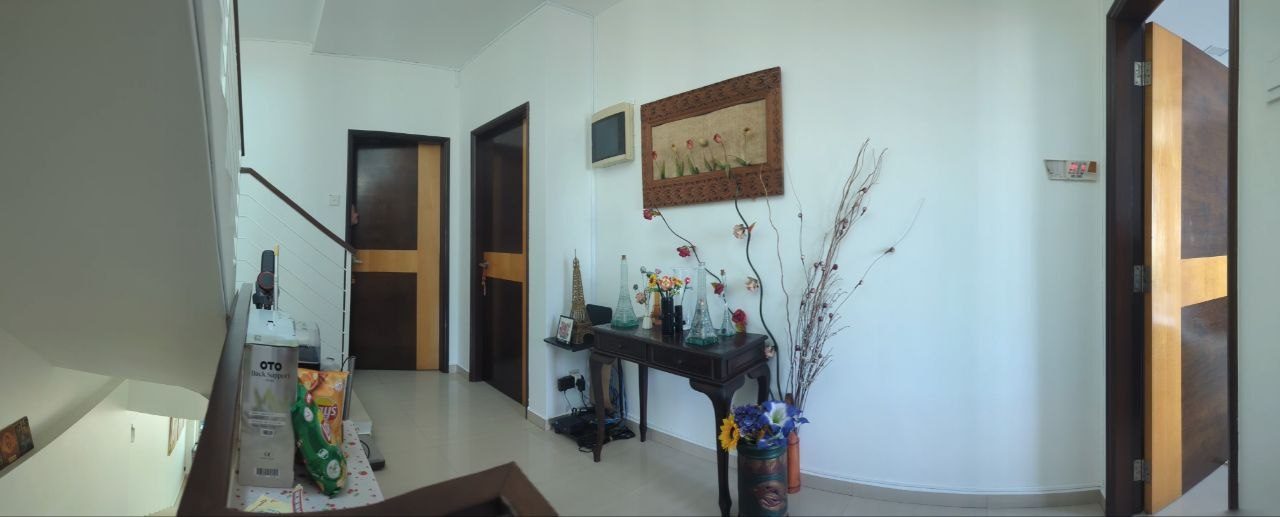 Hallway before editing, with boxes, snacks and vases